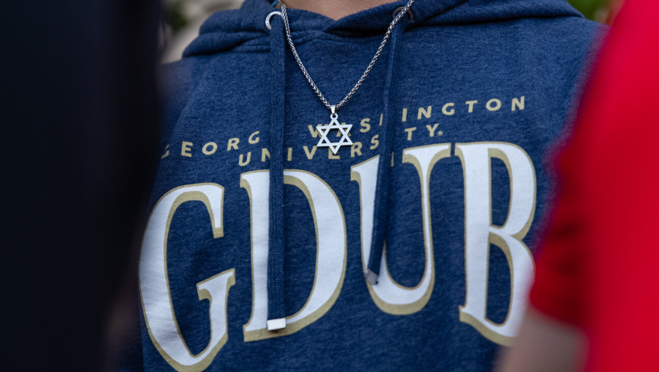 A student attends a campus vigil against antisemitism last November after a replica Torah was vandalized.