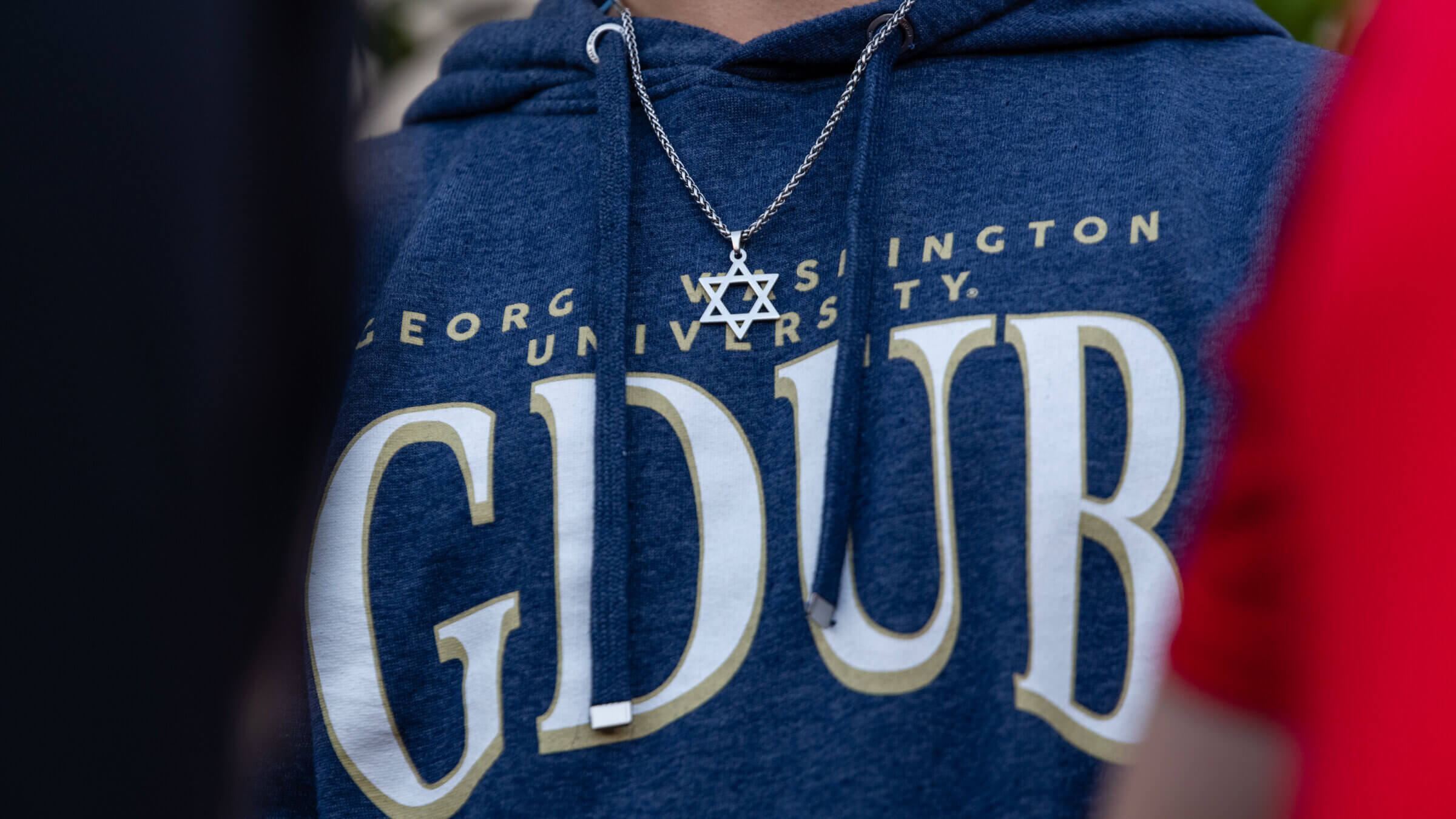 A student attends a campus vigil against antisemitism last November after a replica Torah was vandalized.