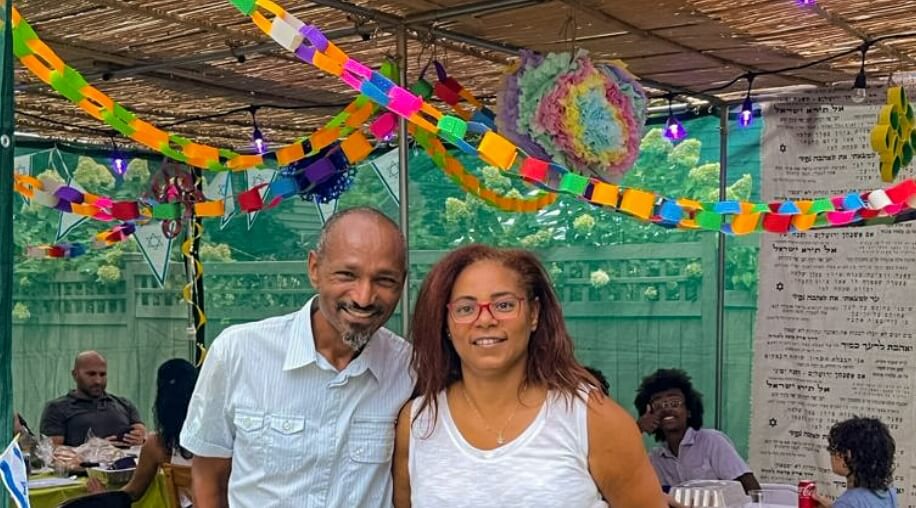 Michal Avera Samuel (right) and her husband Alevel in the community sukkah they built to share with the Jewish community of Columbus, Ohio, last year.