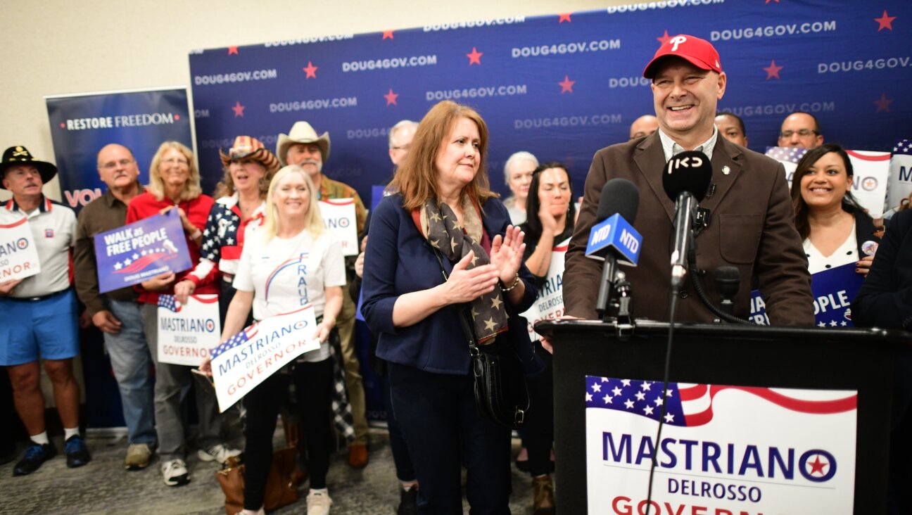 Doug Mastriano addresses the media as his wife Rebecca looks on during a rally in Manheim, Pa., Oct. 29, 2022. 