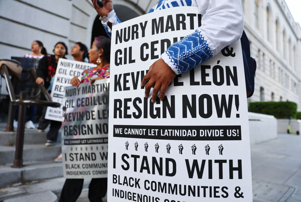 Protestors outside L.A. City Hall call for the resignations of L.A. City Council members Kevin de León and Gil Cedillo in the wake of a leaked audio recording.