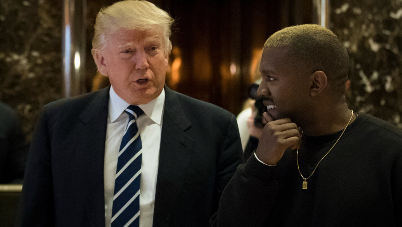 Then President-elect Donald Trump, left, and Kanye West walk into the lobby at Trump Tower, Dec. 13, 2016, in New York City. 