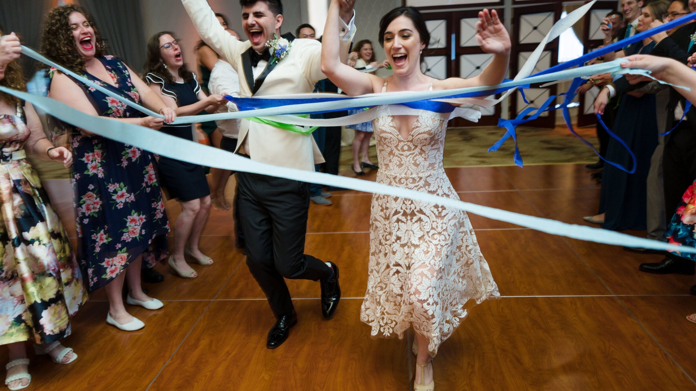 Alex Zeldin, left, and Tamar Caplan dance into the reception at their wedding, Aug. 21, 2022. (JC Lemon Photography)