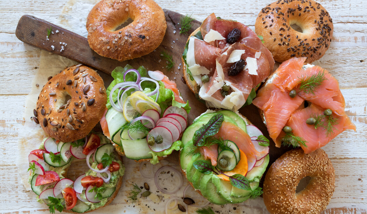 Bagel sandwiches on cutting board.