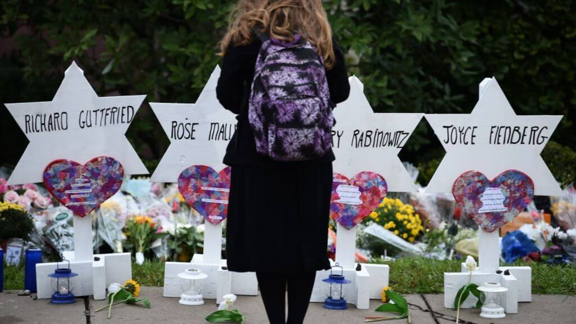 A child stands at a memorial outside the Tree of Life synagogue after a shooting there left 11 people dead in the Squirrel Hill neighborhood of Pittsburgh. 