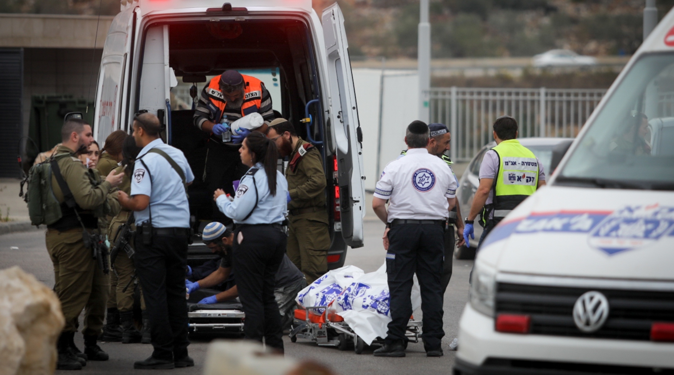 Medics remove the body of a man murdered in a stabbing attack earlier, outside Ariel, in the West Bank, on November 15, 2022. (Flash90)
