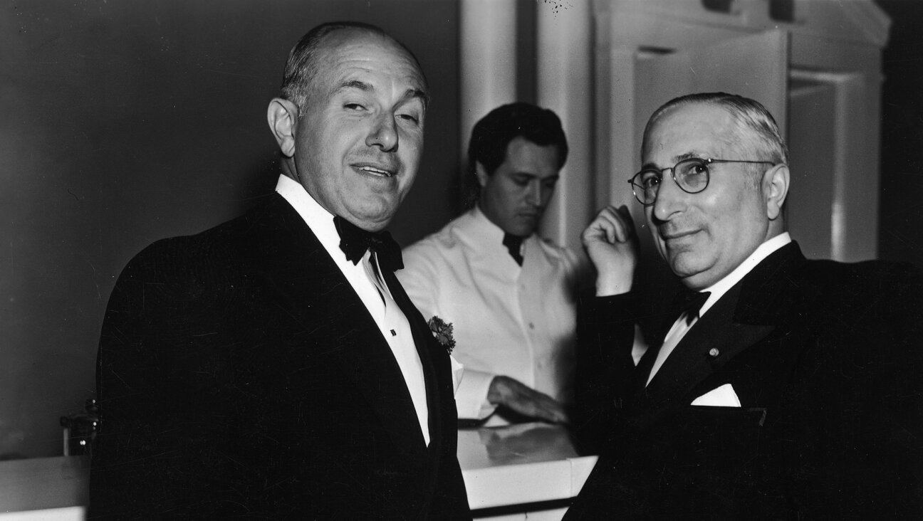 American film executives Jack Warner, left, and Louis Mayer right, together at a bar, 1940. (Hulton Archive/Getty Images)