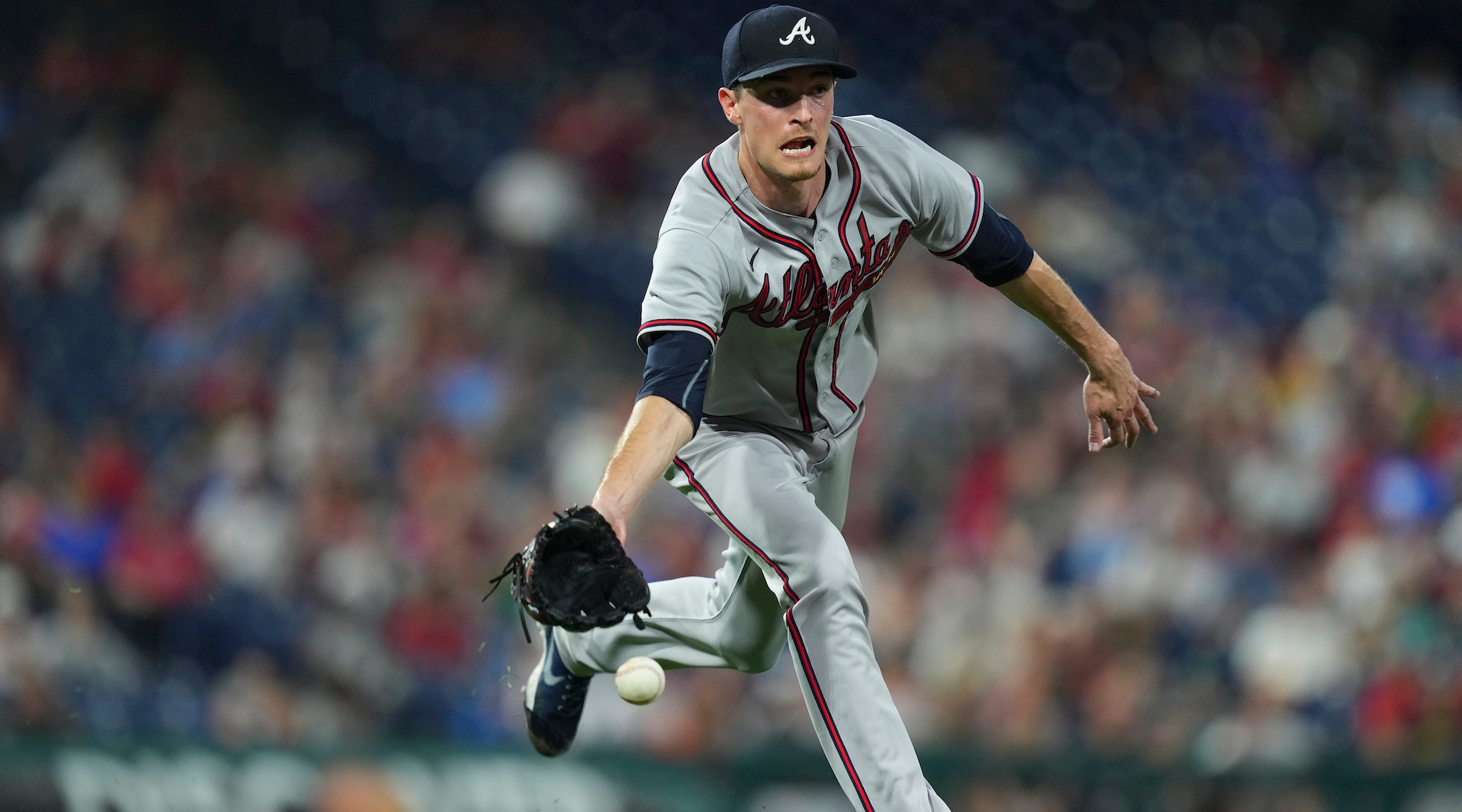 Max Fried flips the ball to first base during a game against the Philadelphia Phillies, July 25, 2022. (Mitchell Leff/Getty Images)
