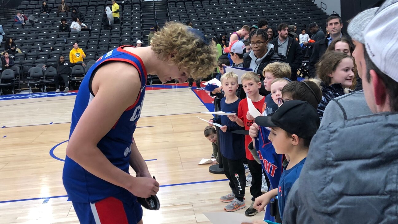 NBA G League player Ryan Turell signs a fan’s yarmulke following his game with Detroit’s Motor City Cruise, Nov. 17, 2022. The Yeshiva University graduate is the first Orthodox Jew to play for an NBA franchise team at any level. (Andrew Lapin/JTA)