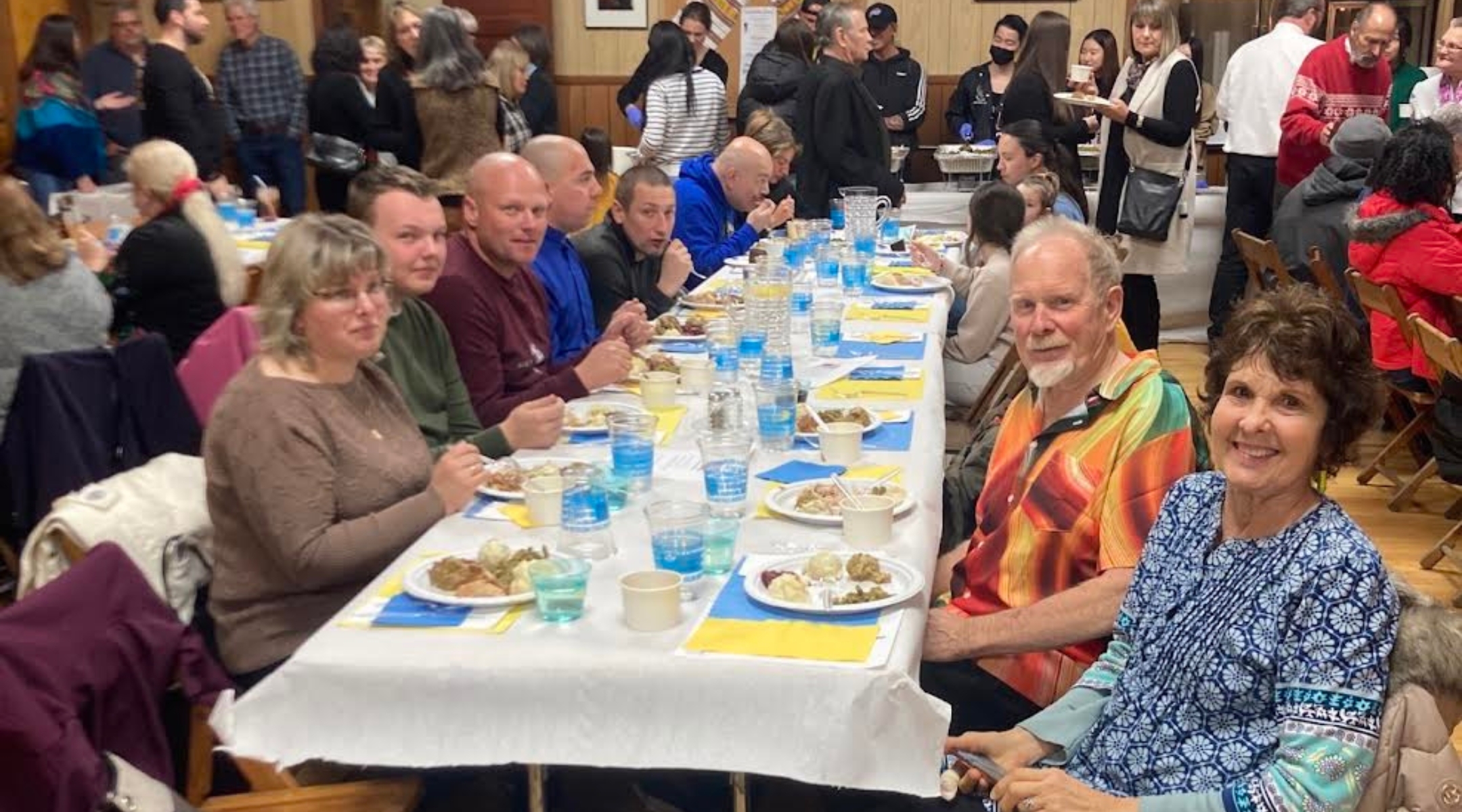 Ukrainian evacuees celebrate a pre-Thanksgiving meal at the Ukrainian American Civic Center in Buffalo, New York. (Courtesy of Jewish Federations of North America)