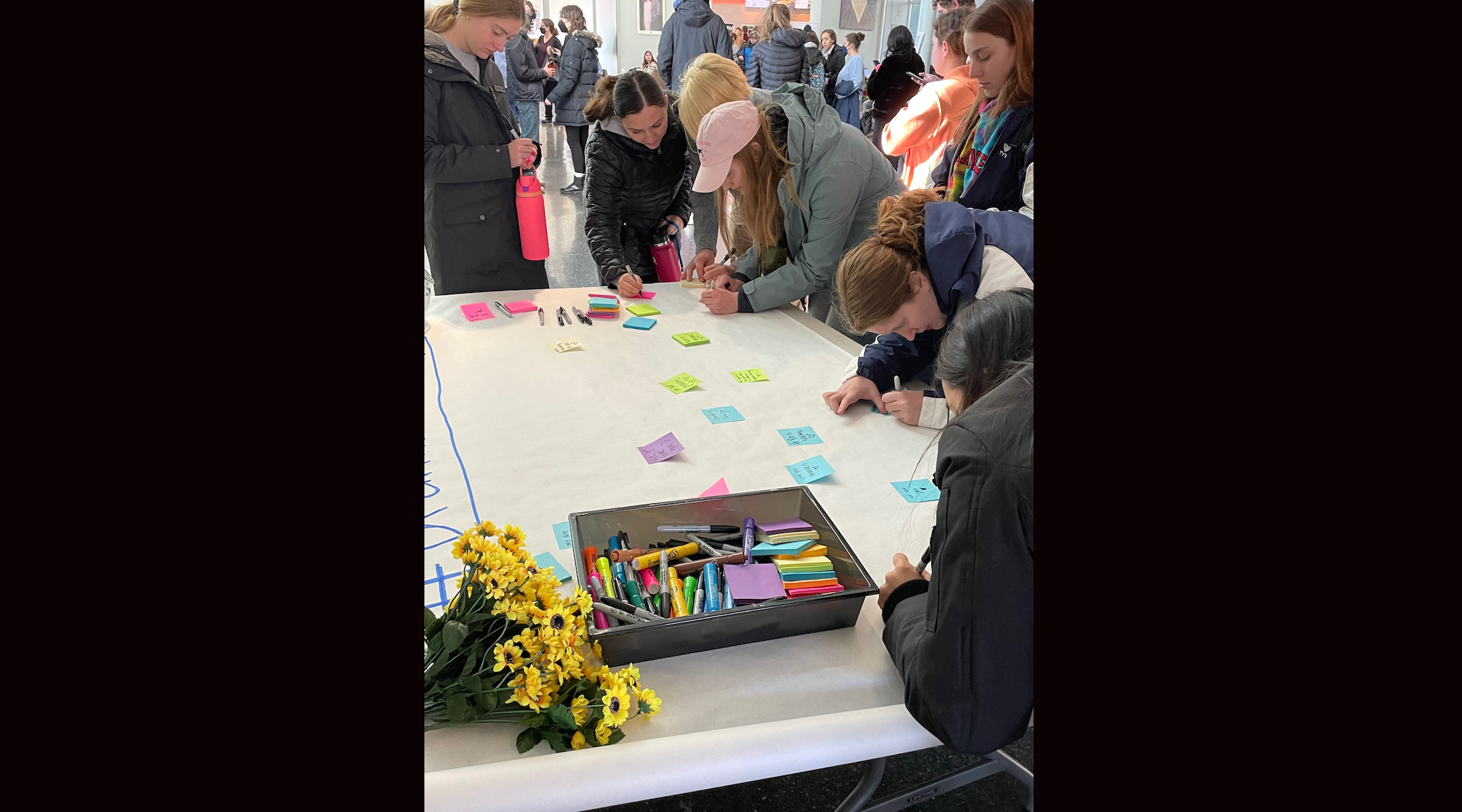 Brandeis University students assemble messages in honor of their classmate who died in a shuttle bus crash that injured dozens of Brandeis students, following a gathering in the Shapiro Student Center, Nov. 20, 2022. (Penny Schwartz)