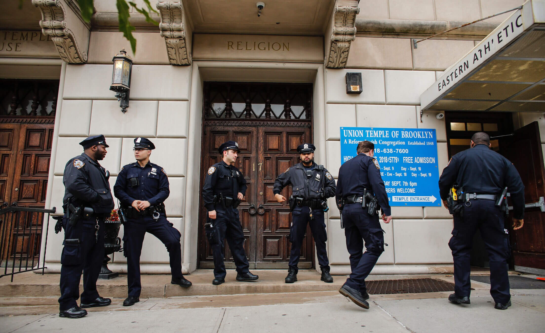 NYPD officers stand guard at the door of the Union Temple of Brooklyn on November 2, 2018.