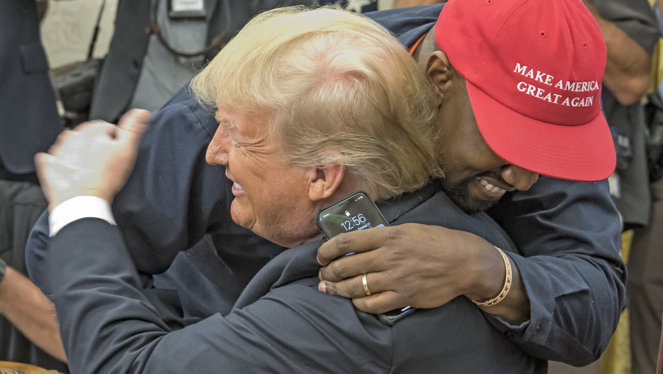 Kanye West embraces  Donald Trump in the White House's Oval Office in 2018.