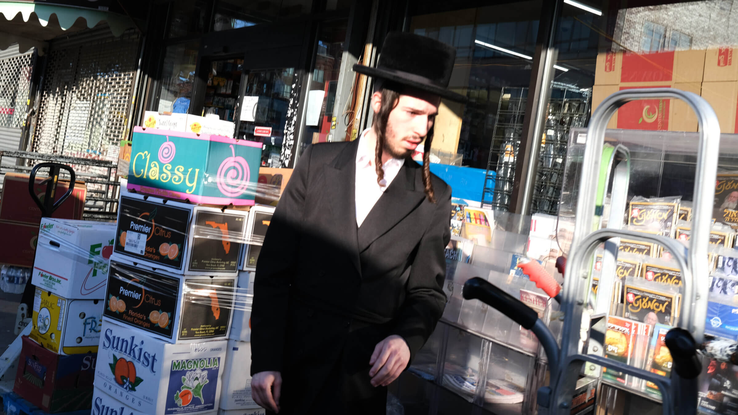 A man walks by a newsstand in the Borough Park neighborhood of Brooklyn. <i>Shtetl</i>, a new online publication, seeks to provide "independent" coverage of the Haredi community.