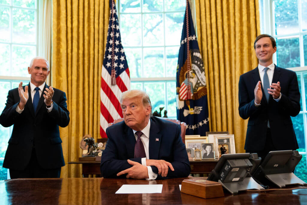 President Donald Trump, flanked by U.S. Vice President Mike Pence, left, and advisor Jared Kushner, right, speaks in the Oval Office on Sept. 11, 2020.