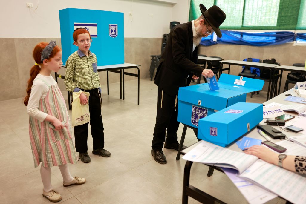 A voter casts his ballot Tuesday morning in Bnei Brak. (Getty)