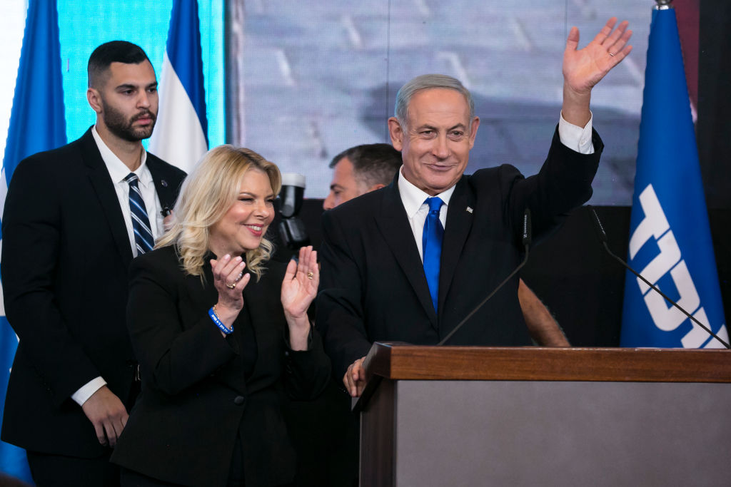 Former Israeli Prime Minister Benjamin Netanyahu and wife, Sara, greet supporters on Tuesday night. (Getty)