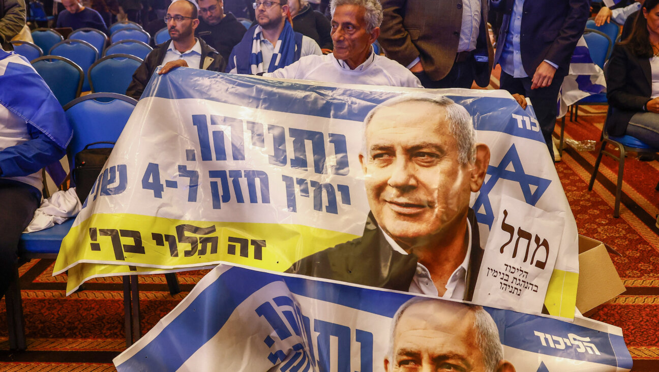 A supporter at the Likud party headquarters in Jerusalem, Israel, on Tuesday, Nov. 1, 2022. The sign he is holding reads, in Hebrew, "Netanyahu. A strong right for 4 years. It's up to you!"