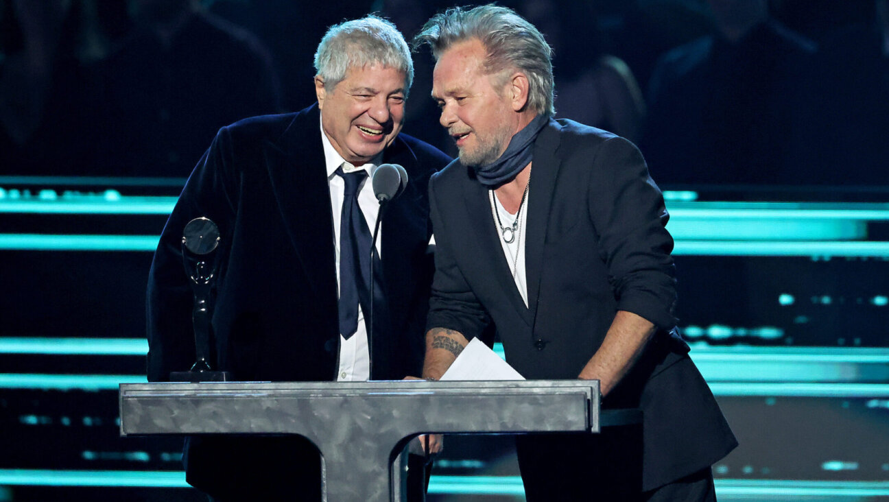 Attorney Allen Grubman, left, and rocker John Mellencamp speak onstage during the 37th Annual Rock & Roll Hall of Fame Induction Ceremony in Los Angeles, Nov. 5, 2022. (Amy Sussman/WireImage)