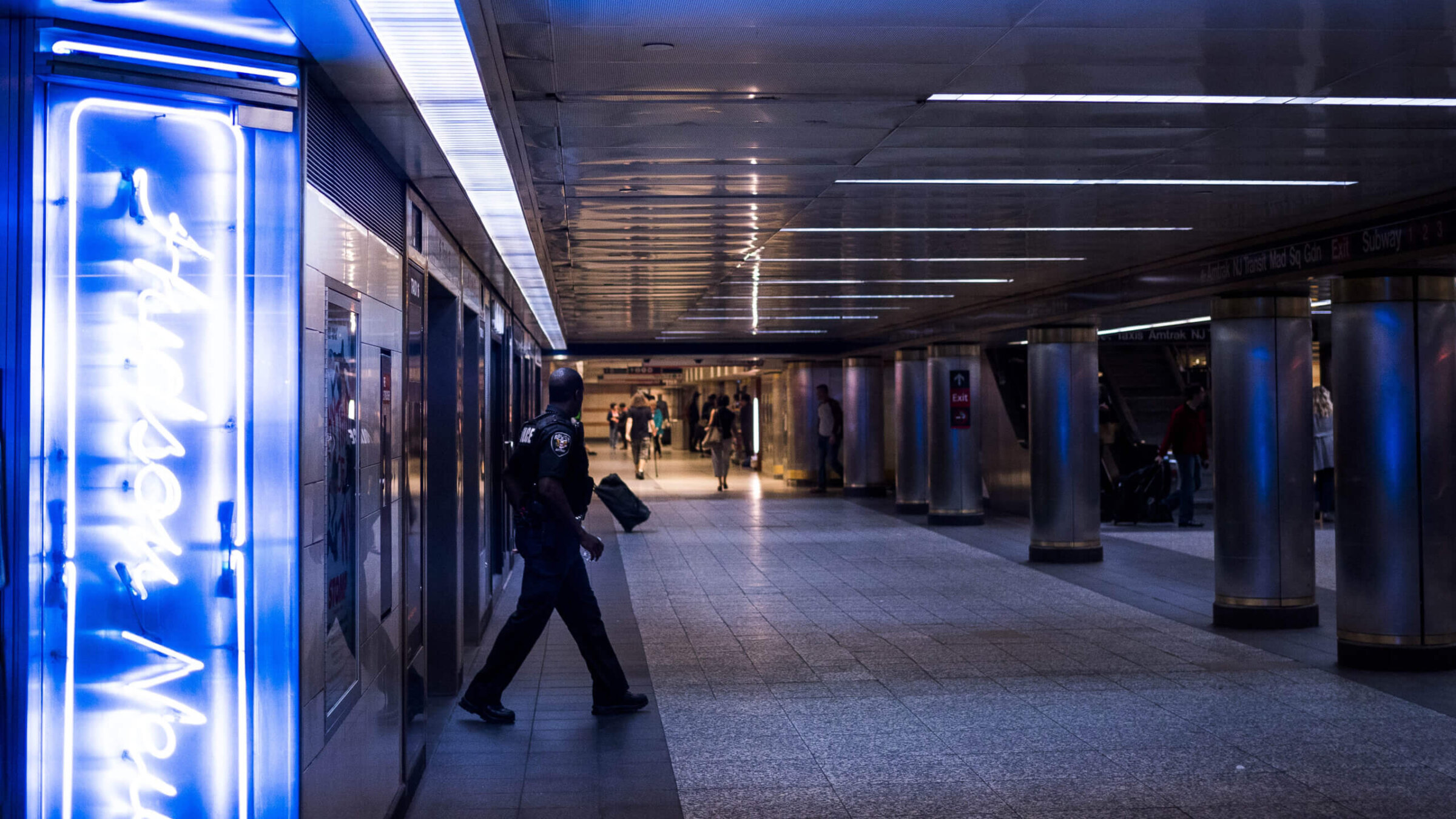 A police officer walks through Penn Station.