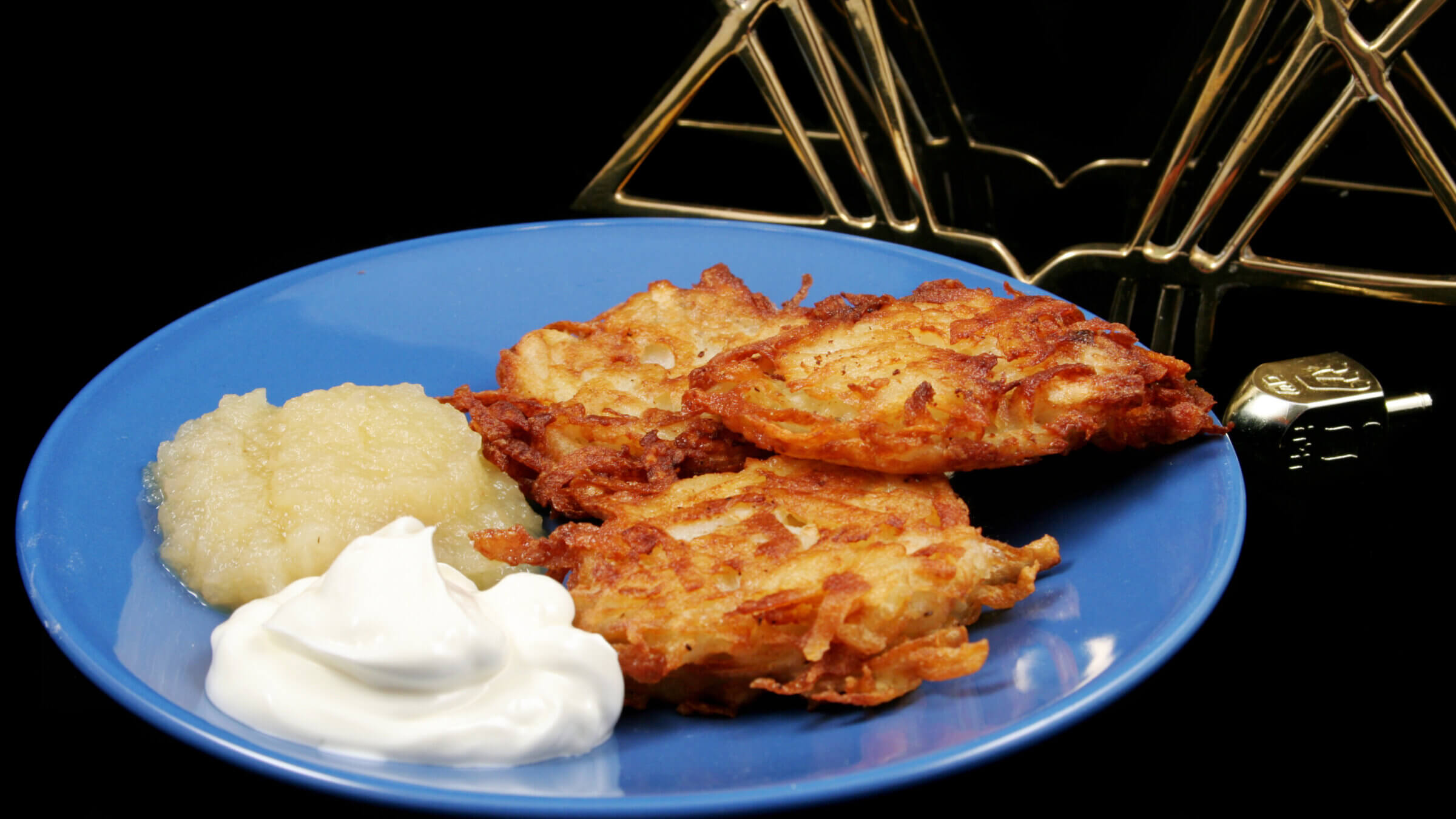 Potato latkes for Hanukkah, with applesauce and sour cream on the side.