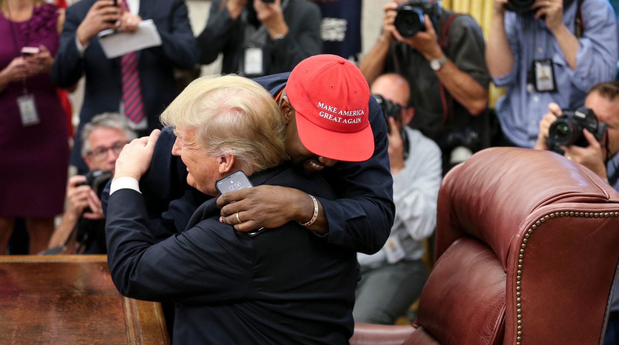 Rapper Kanye West hugs U.S. President Donald Trump during a meeting in the Oval office of the White House, Oct. 11, 2018. (Oliver Contreras – Pool/Getty Images)