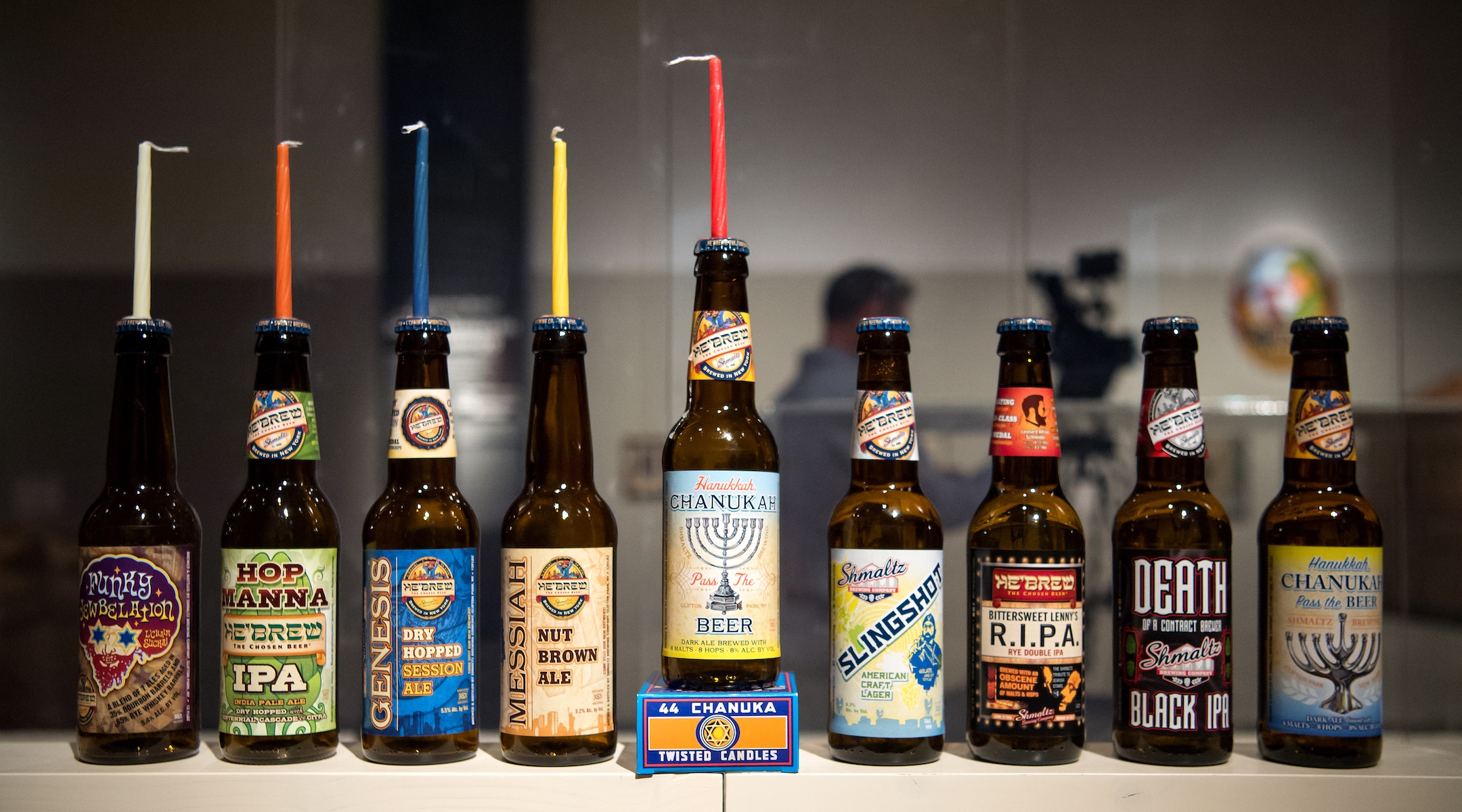 Various beer bottles by Shmaltz Brewery on display in an exhibition on “Jewish brewing stories” at the Jewish Museum in Munich, Germany, April 11, 2016. (Sven Hoppe/picture alliance via Getty Images)