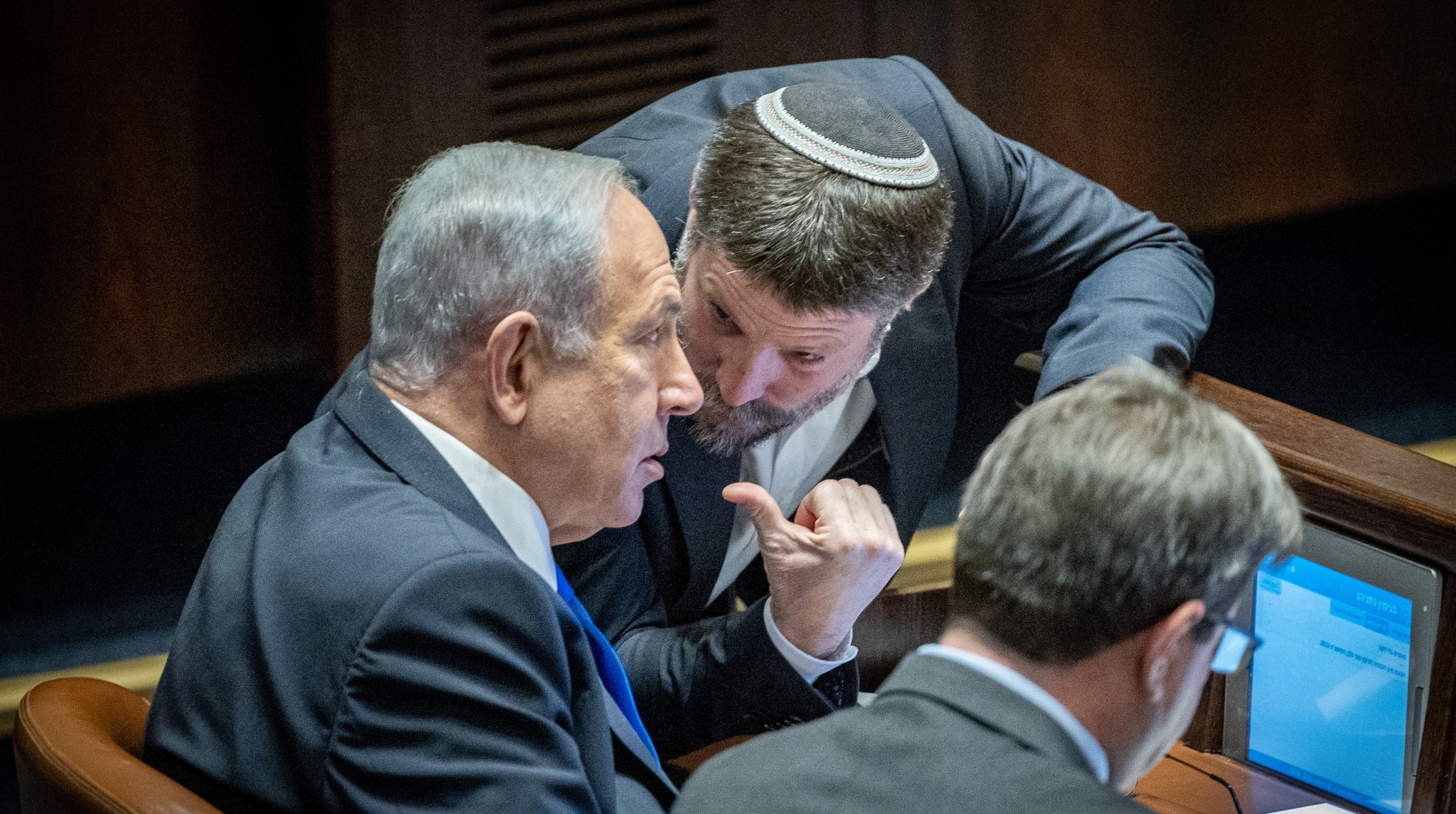 Likud leader MK Benjamin Netanyahu speaks with Religious Zionist party head MK Bezalel Smotrich during a vote in the plenum session at the assembly hall of the Knesset, the Israeli parliament in Jerusalem, Dec. 20, 2022. (Yonatan Sindel/Flash90)