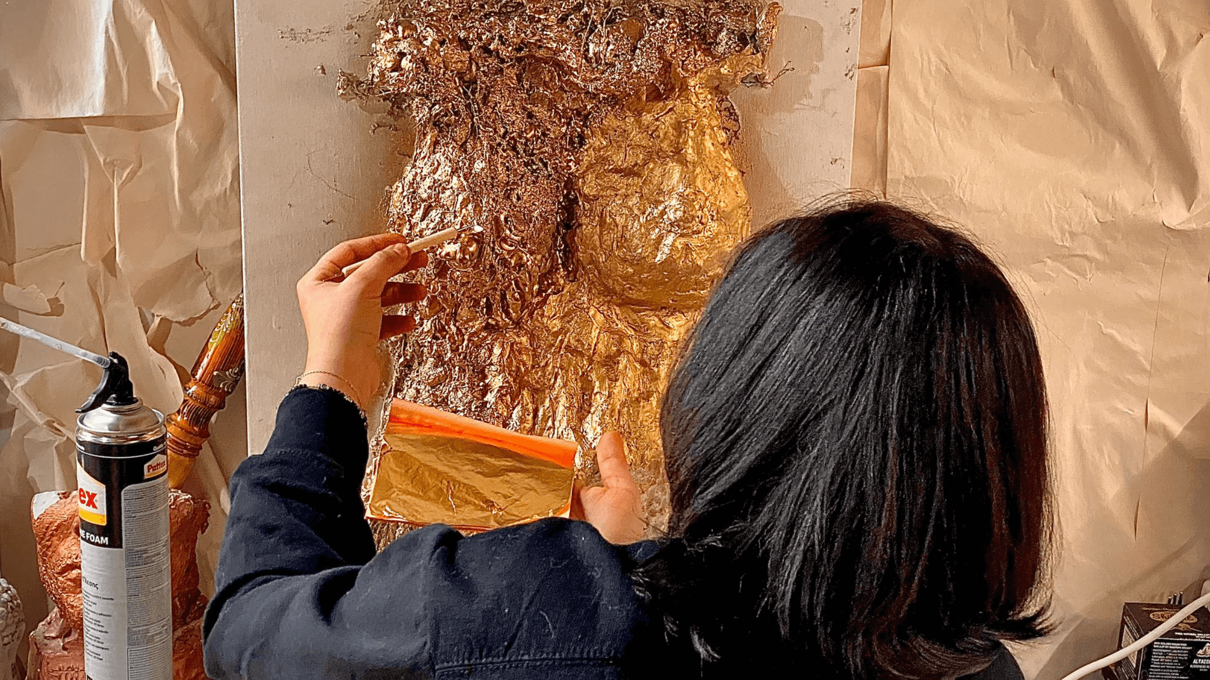 Artist Nidaa Badwan works on her new sculpture of gold leaf, inspired by the death of 22-year old Mahsa Amini. 