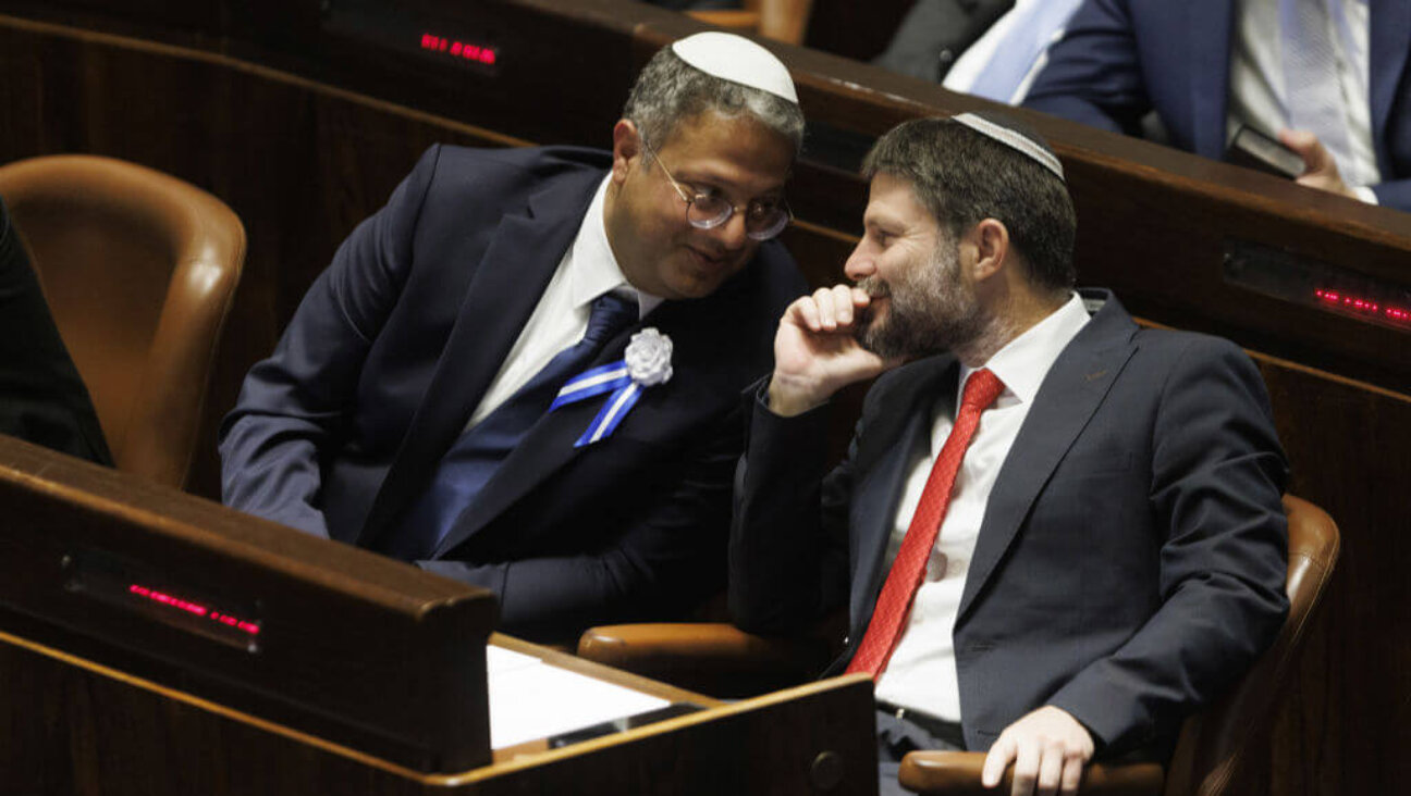 The two most controversial new members of Benjamin Netanyahu's new government: Itamar Ben Gvir, lawmaker and leader of the Otzma Yehudit party, <i>left</i>, speaks with Bezalel Smotrich, lawmaker and leader of the Religious Zionist party, during a swearing in ceremony at the Knesset in Jerusalem Nov. 15. 