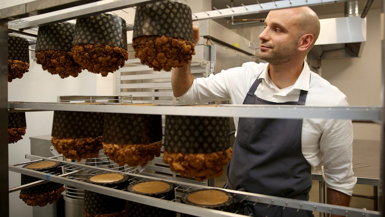 Chef Roy Shvartzapel checks the temperature of panettone just out of the oven in his Richmond, California, kitchen, in 2016.