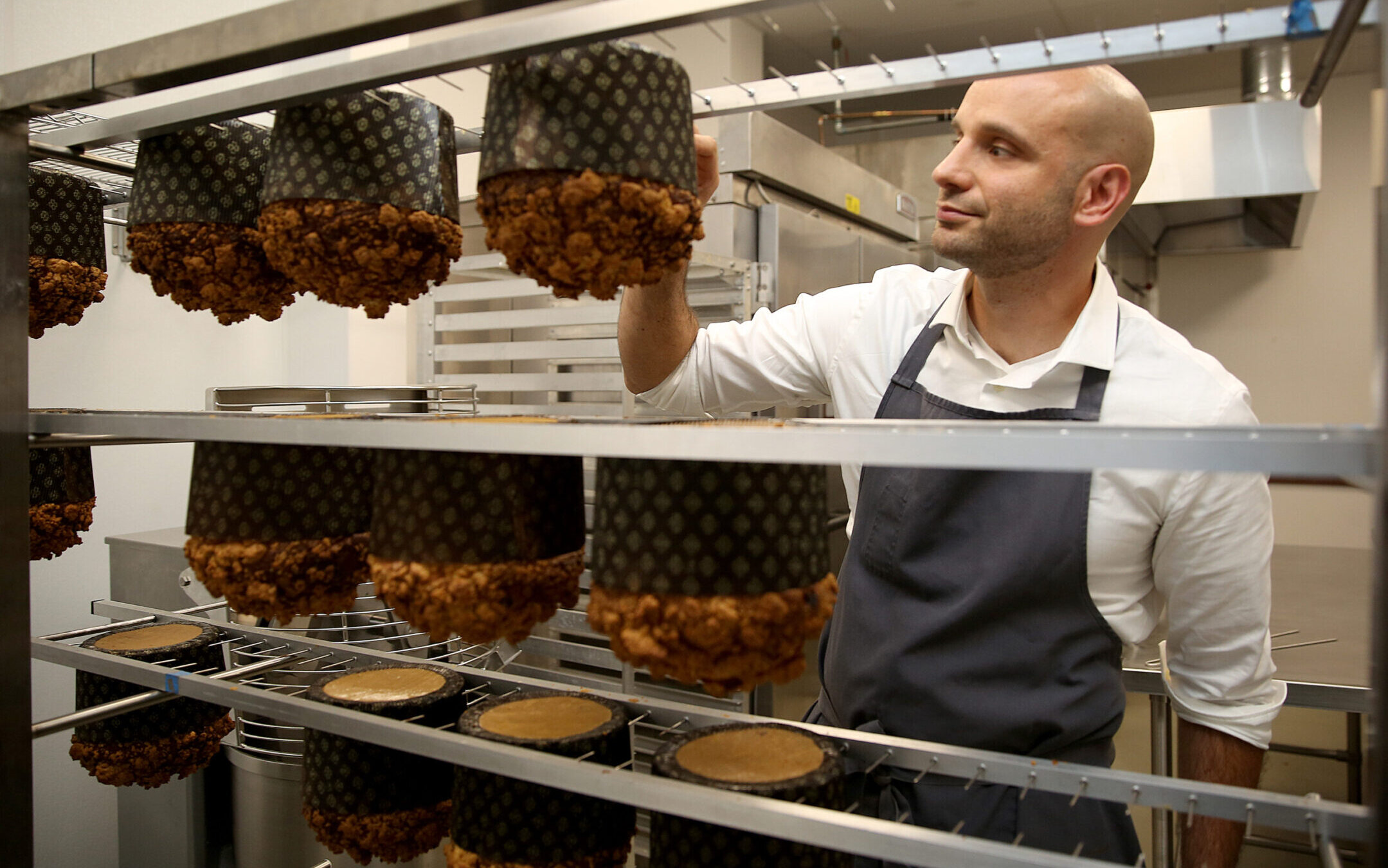 Chef Roy Shvartzapel checks the temperature of panettone just out of the oven in his Richmond, California, kitchen, in 2016.