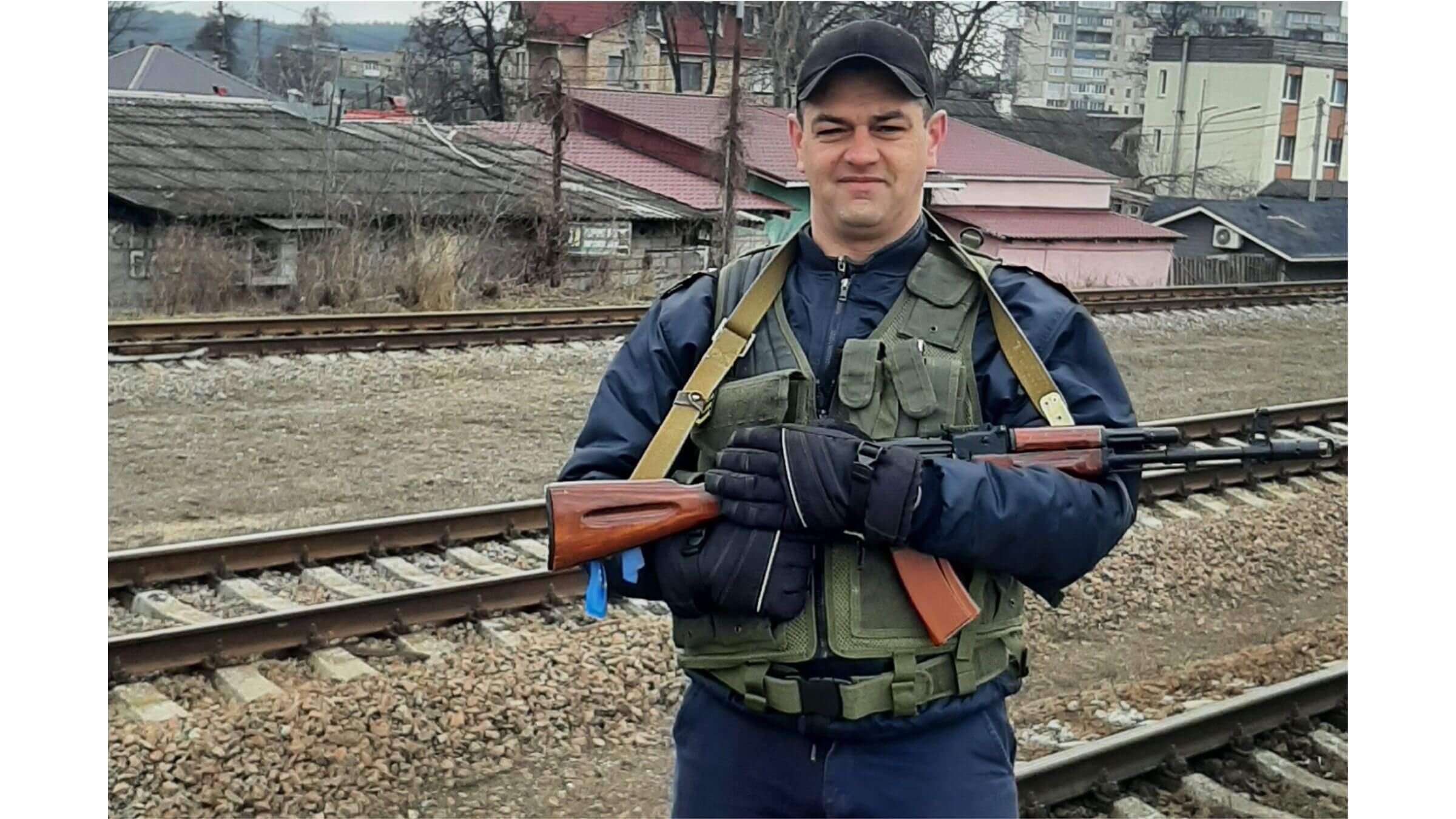 Serhii Pruzhanskyi with a rifle and a bulletproof vest.