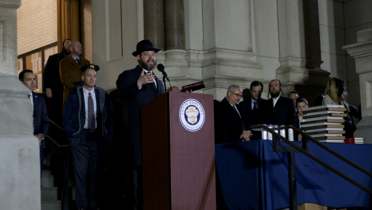 A chabad rabbi stands at a podium outside of city hall in Jersey City, NJ.
