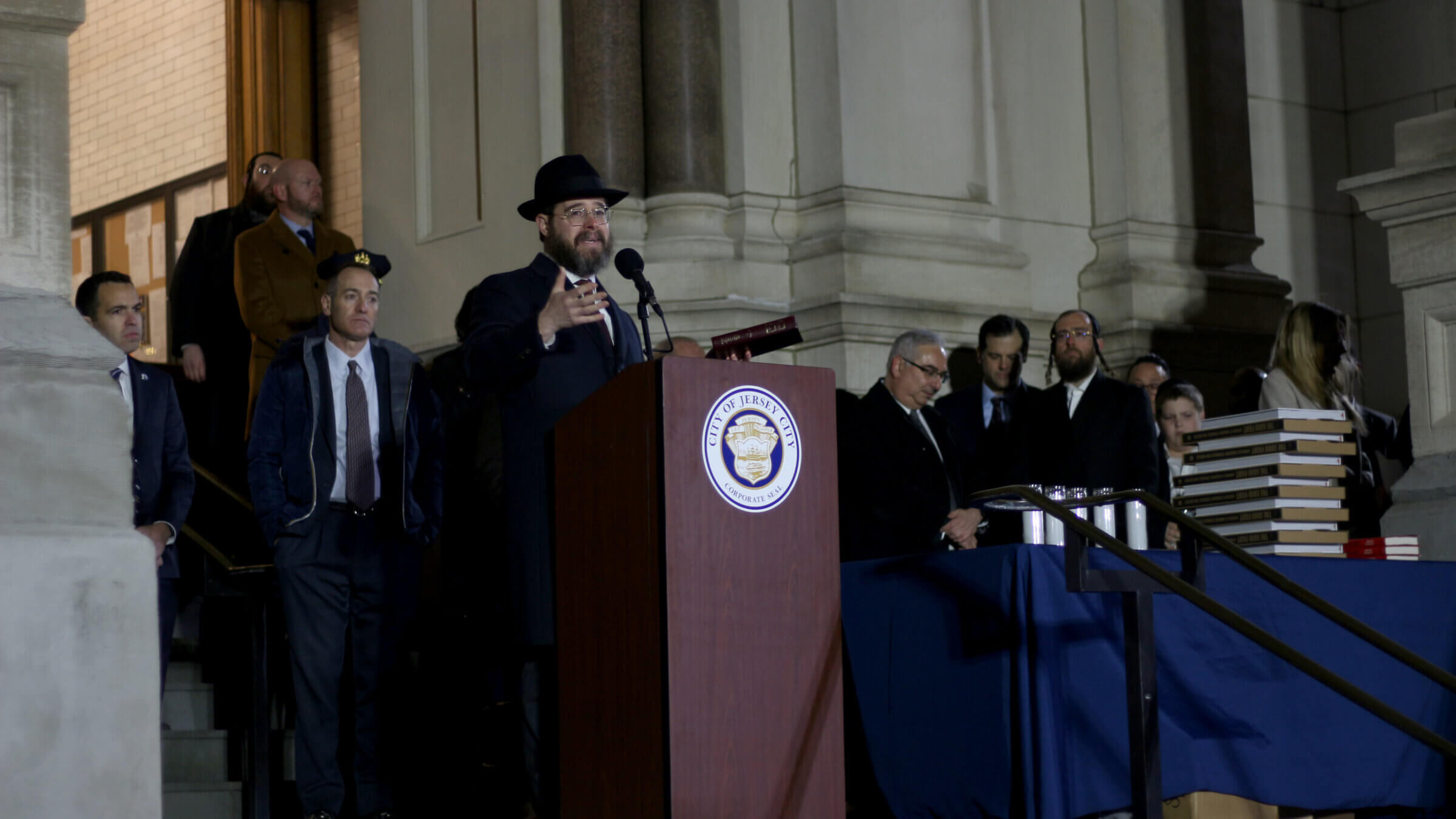 Rabbi Moshe Shapiro of the Chabad of Hoboken and Jersey City led the crowd outside of City Hall in the mourner's kaddish.