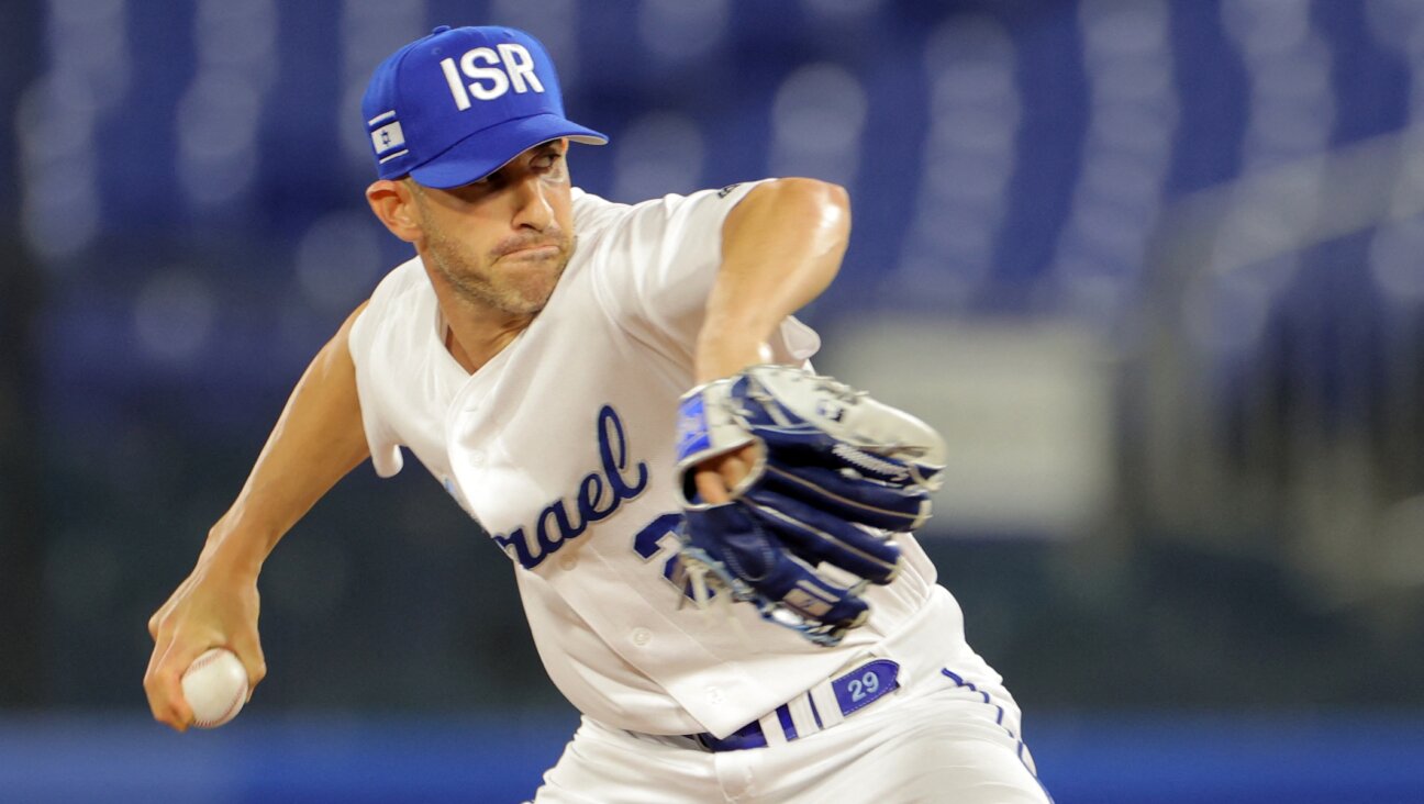 Alon Leichman, recently hired as a pitching coach for the Cincinnati Reds, pitches for Team Israel during the eighth inning of the Tokyo Olympic Games baseball opening round game against the United State in Yokohama, Japan, July 30, 2021. (Kazuhiro Fujihara/AFP via Getty Images)