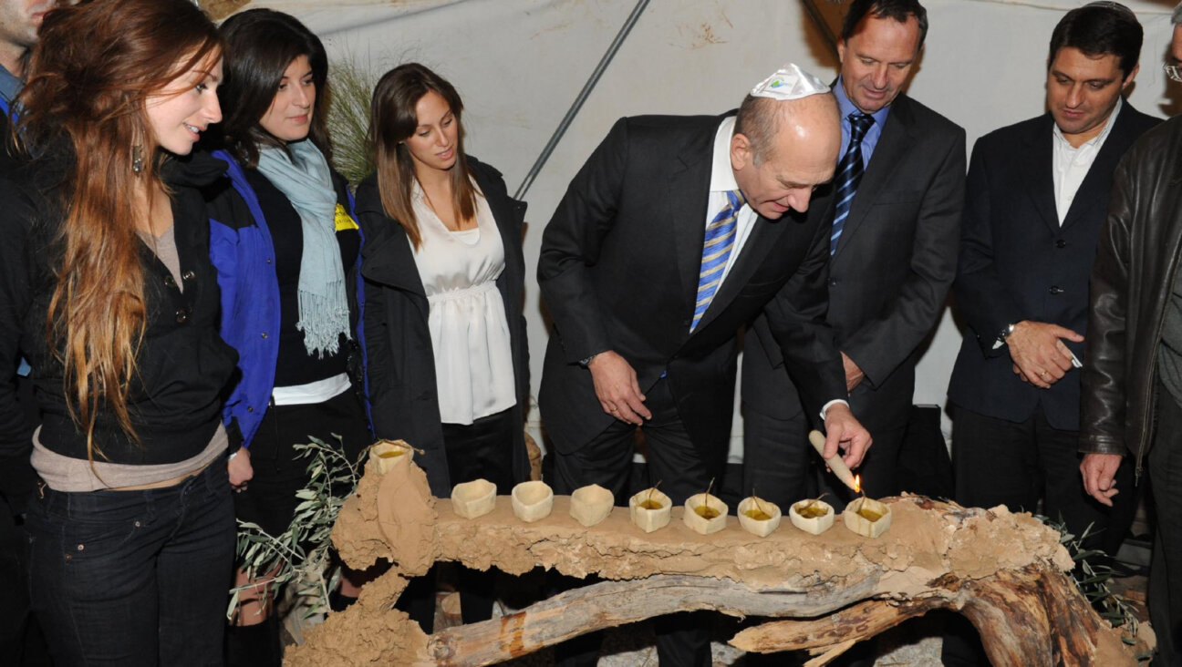 Then Israeli Prime Minister Ehud Olmert lights Hannukah candles on Dec. 25, 2008, in Modi'in, Israel. 