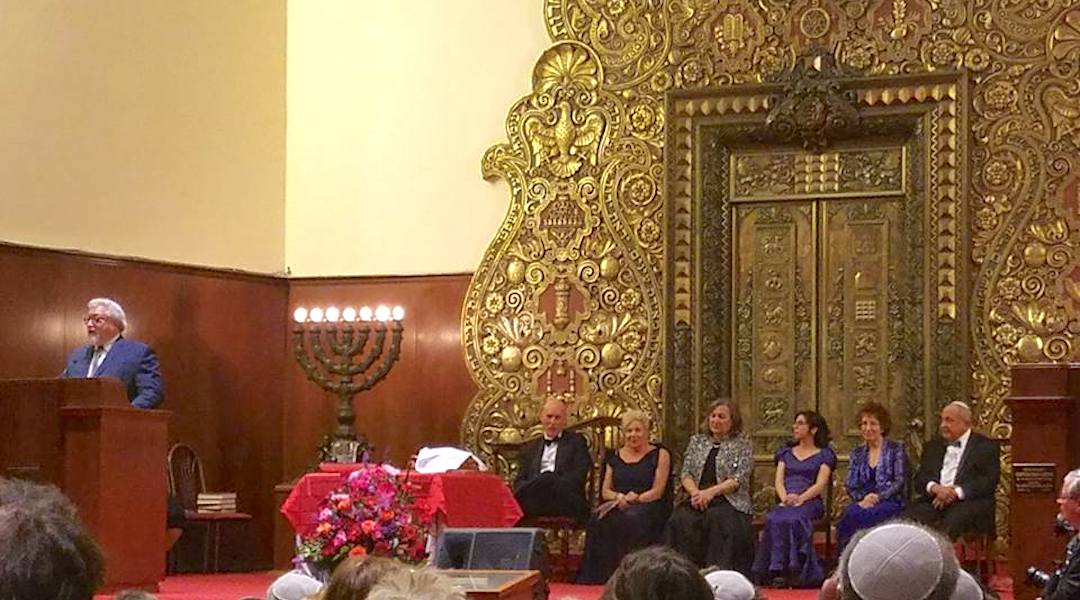 Rabbi Gerald C. Skolnik, spiritual leader of the Forest Hills Jewish Center, presides over a ceremony in front of the opulent ark designed by the late Polish-born artist Arthur Szyk. (Courtesy FHJC)