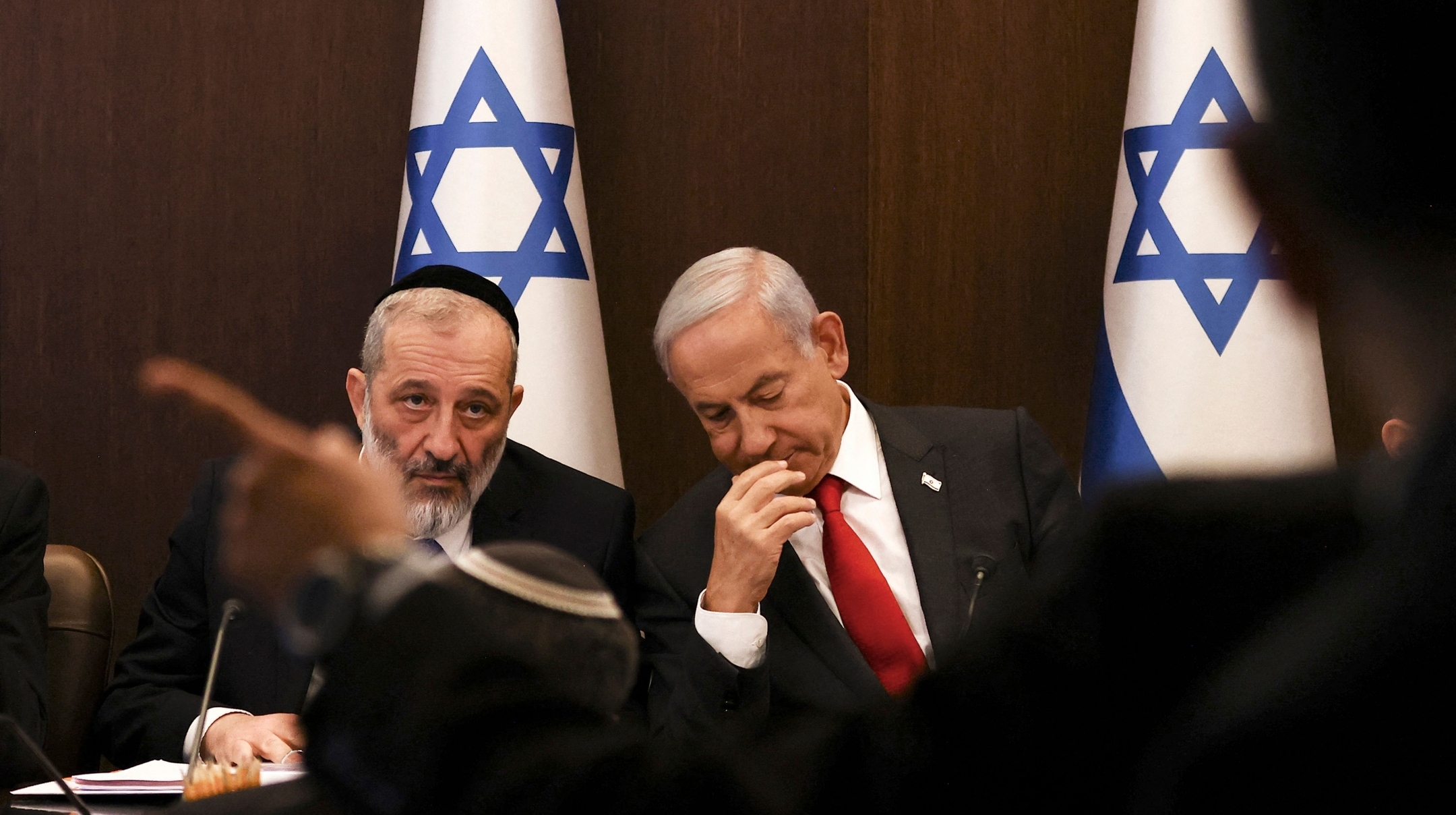 Israel’s Prime Minister Benjamin Netanyahu, right, sits next to Interior and Health Minister Aryeh Deri during a weekly Cabinet meeting at the prime minister’s office in Jerusalem, Jan. 8, 2023. (Ronen Zevulun/Pool/AFP via Getty Images)