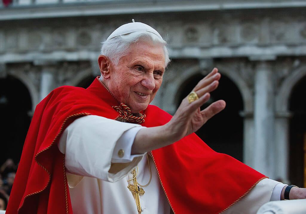 Pope Benedict XVI greets the crowd gathered in St Mark's Square while crossing the square on an electric car on May 7, 2011 in Venice, Italy. 