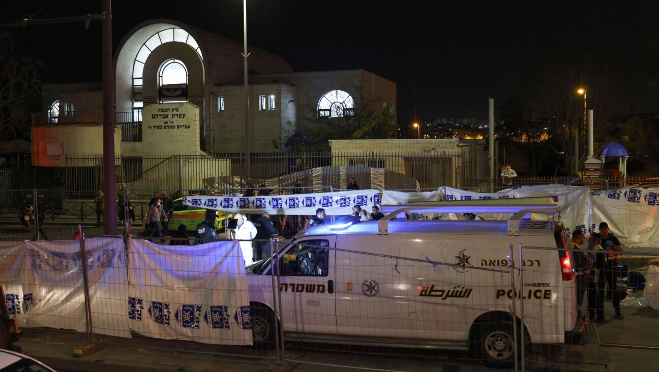 Israeli emergency service personnel close off the site of a reported attack at a synagogue in East Jerusalem.