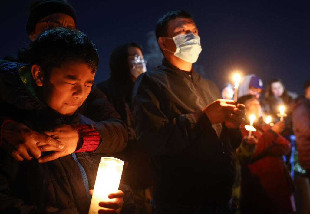 People gather at a candlelight vigil for victims of a deadly mass shooting at a ballroom dance studio on Jan. 23, 2023 in Monterey Park, California.