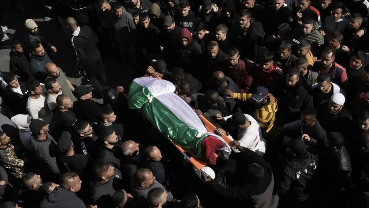 Mourners carry the body of a Palestinian woman, identified as Magda Obaid, 60, during her funeral in the West Bank city of Jenin, Thursday, Jan. 26, 2023. Palestinian health officials said Israeli forces killed at least nine Palestinians, including the Palestinian woman, and wounded several others during a raid in a flashpoint area of the occupied West Bank on Thursday, in one of the deadliest days in months of unrest. 