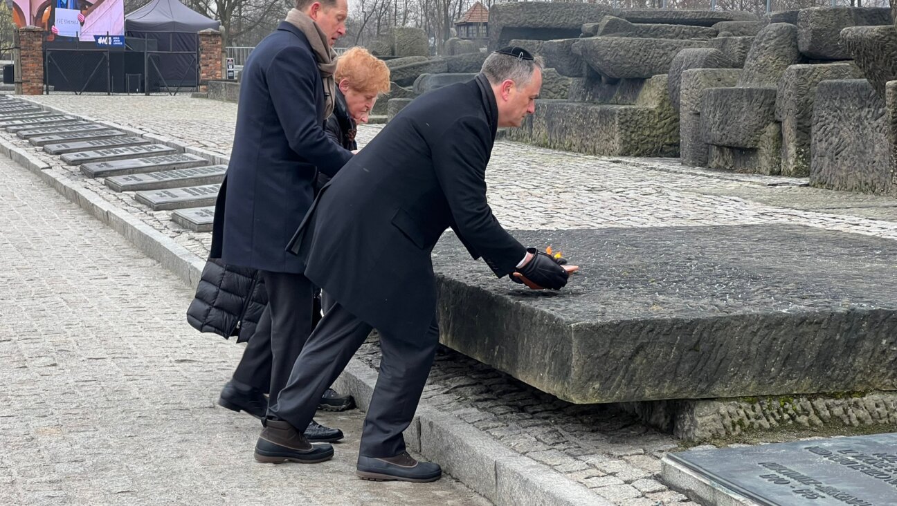 Ambassador Deborah Lipstadt, U.S. Ambassador to Poland Mark Brzezinski and Second Gentleman Doug Emhoff lay bowls of fire at a memorial in Birkenau.