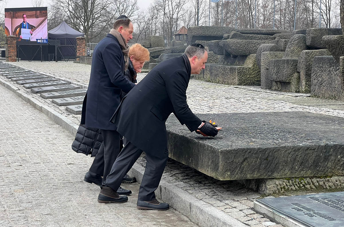 Ambassador Deborah Lipstadt, U.S. Ambassador to Poland Mark Brzezinski and second gentleman Doug Emhoff lay bowls of fire Friday morning at a memorial in Birkenau. (Laura E. Adkins)