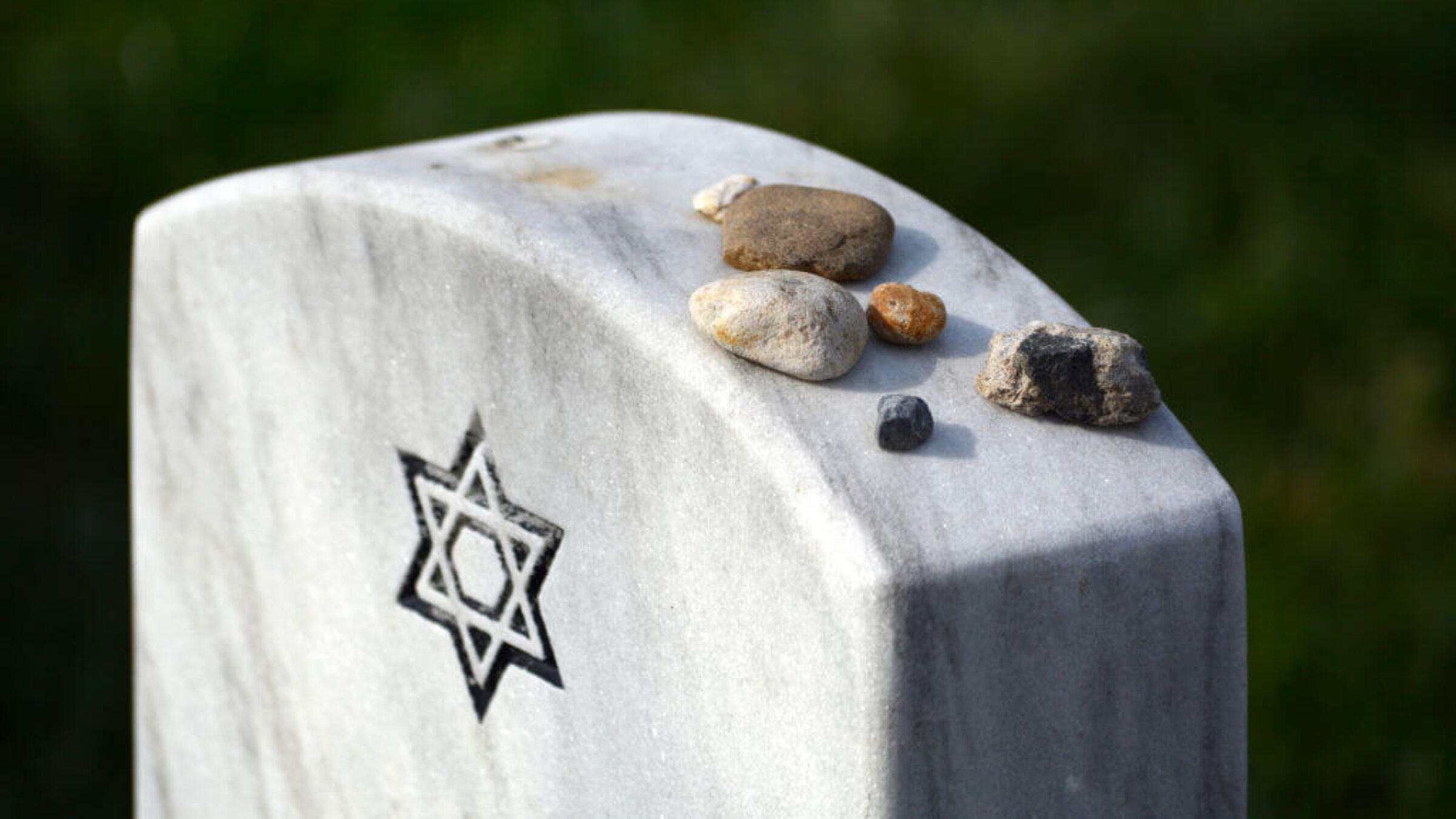 Stones placed by visitors on top of the tombstone of a Jewish U.S. military and World War II veteran at Arlington National Cemetery, April 22, 2018.