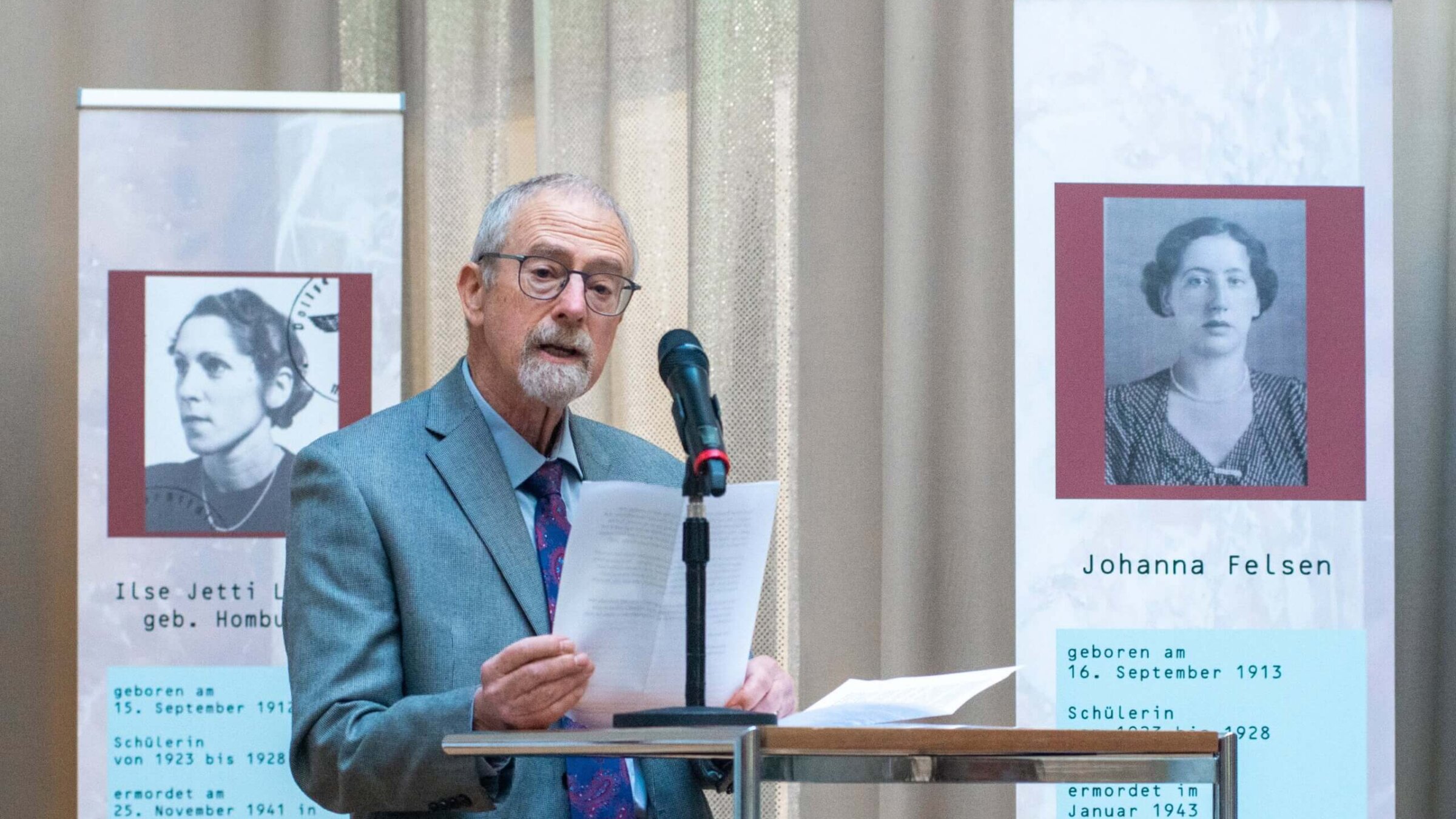 Michael Felsen speaks at the Luisengymnasium in Munich, Germany, memorializing his deceased aunt Johanna (pictured at right) on Nov. 23, 2022. Johanna and nineteen of her classmates were murdered in the Holocaust. 