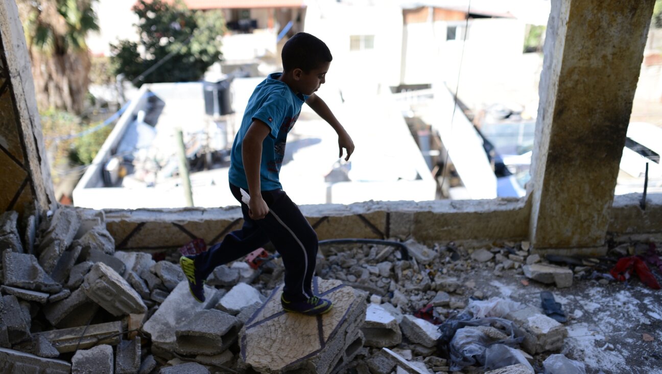 Relatives of Palestinian AbdelRahman al-Shaludi, blamed for killing two Israelis in a deadly vehicular attack last month, inspect the their family home after it was destroyed by Israeli forces in Silwan neighborhood, eastern Jerusalem on Nov. 19, 2014. (Salih Zeki Fazlioglu/Anadolu Agency/Getty Images)