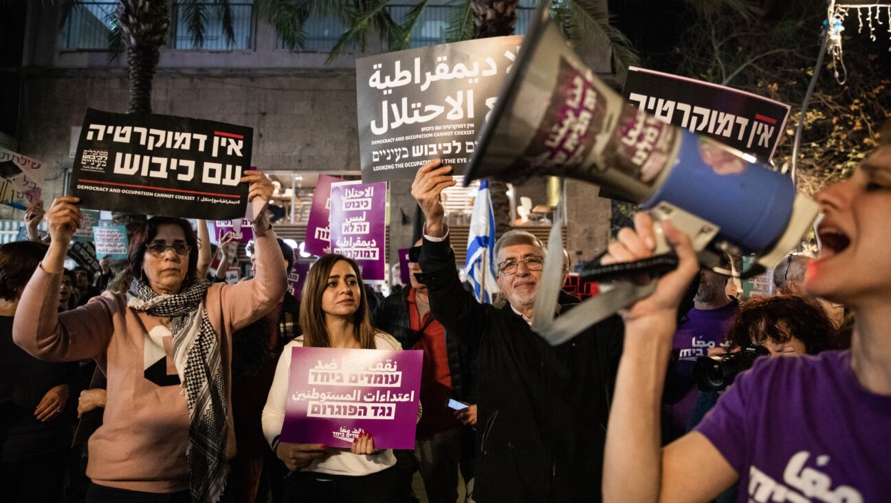 Left-wing activists in Haifa protest against the February events in Hawara. Their signs read, "No democracy with occupation."