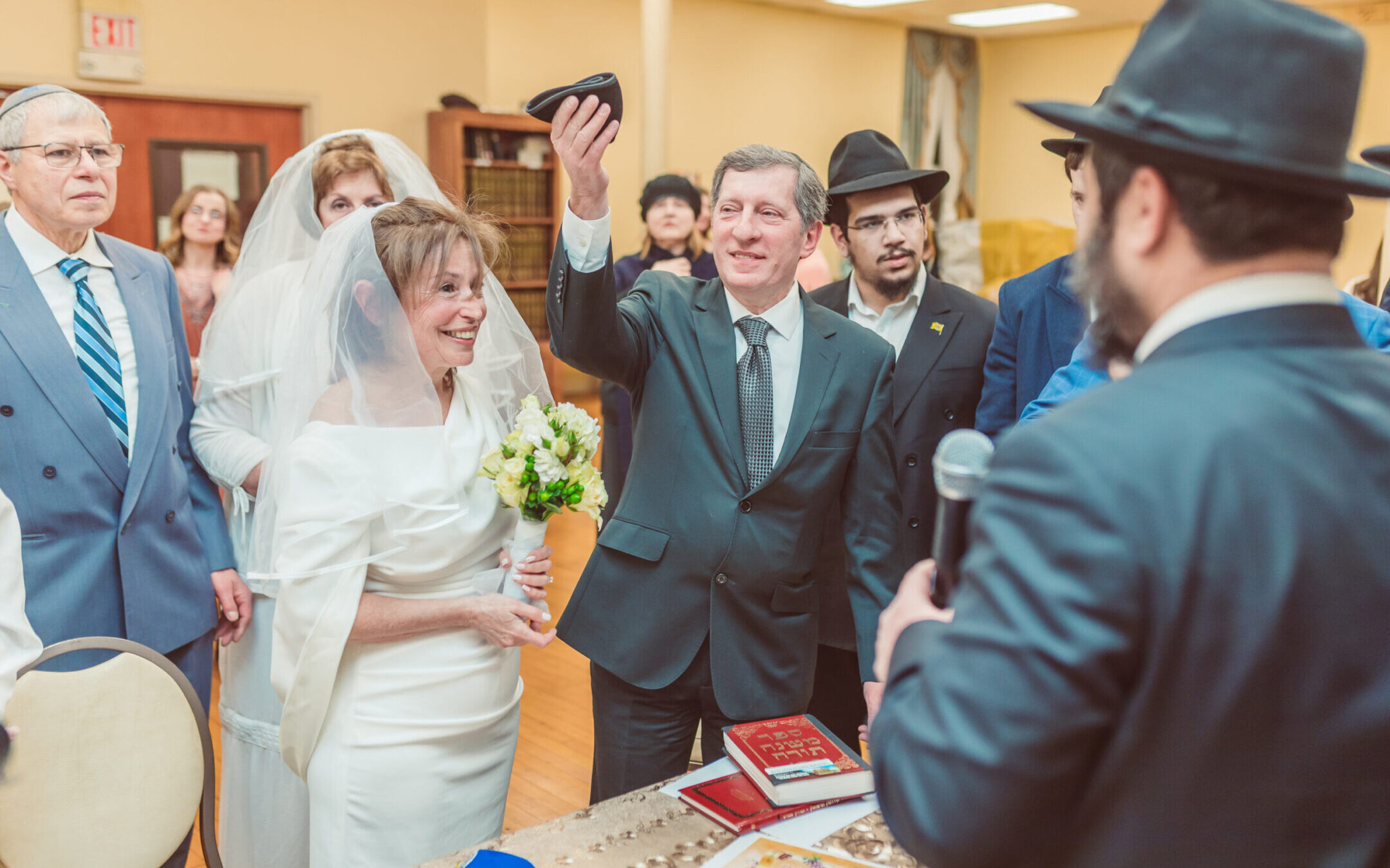 Alex Linkov raises a kippah, in a symbol of a Jewish wedding contract, next to his wife Rimma. The pair had a Jewish wedding in Boston after being married decades earlier in Ukraine. (Photo by Igor Klimov)
